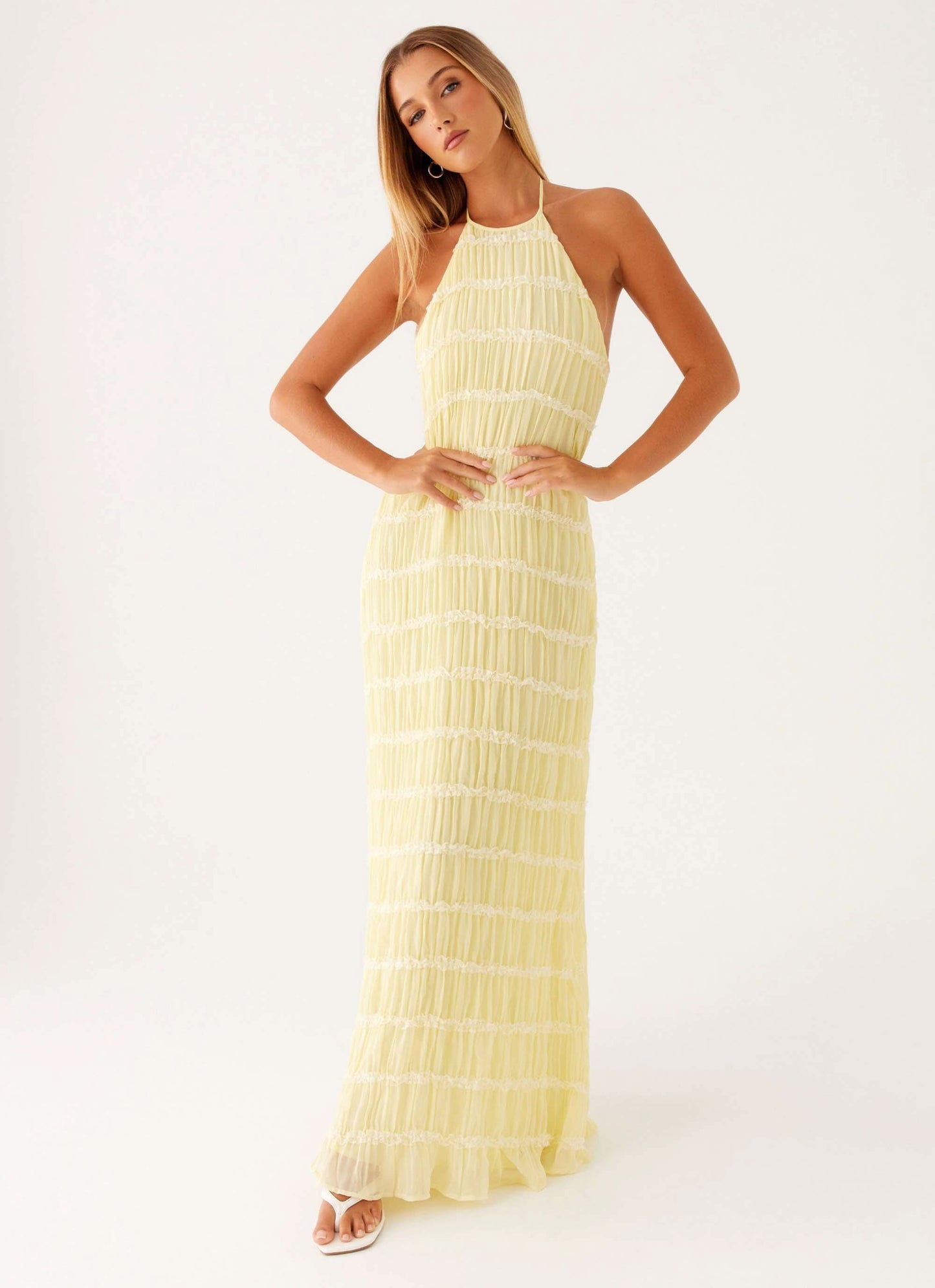 Pale yellow pleated halter maxi dress front view with cropped bodice