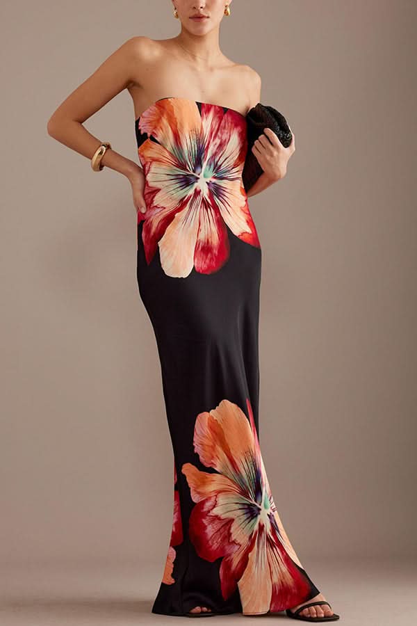 Black satin maxi dress with vibrant red and orange floral blooms, strapless design