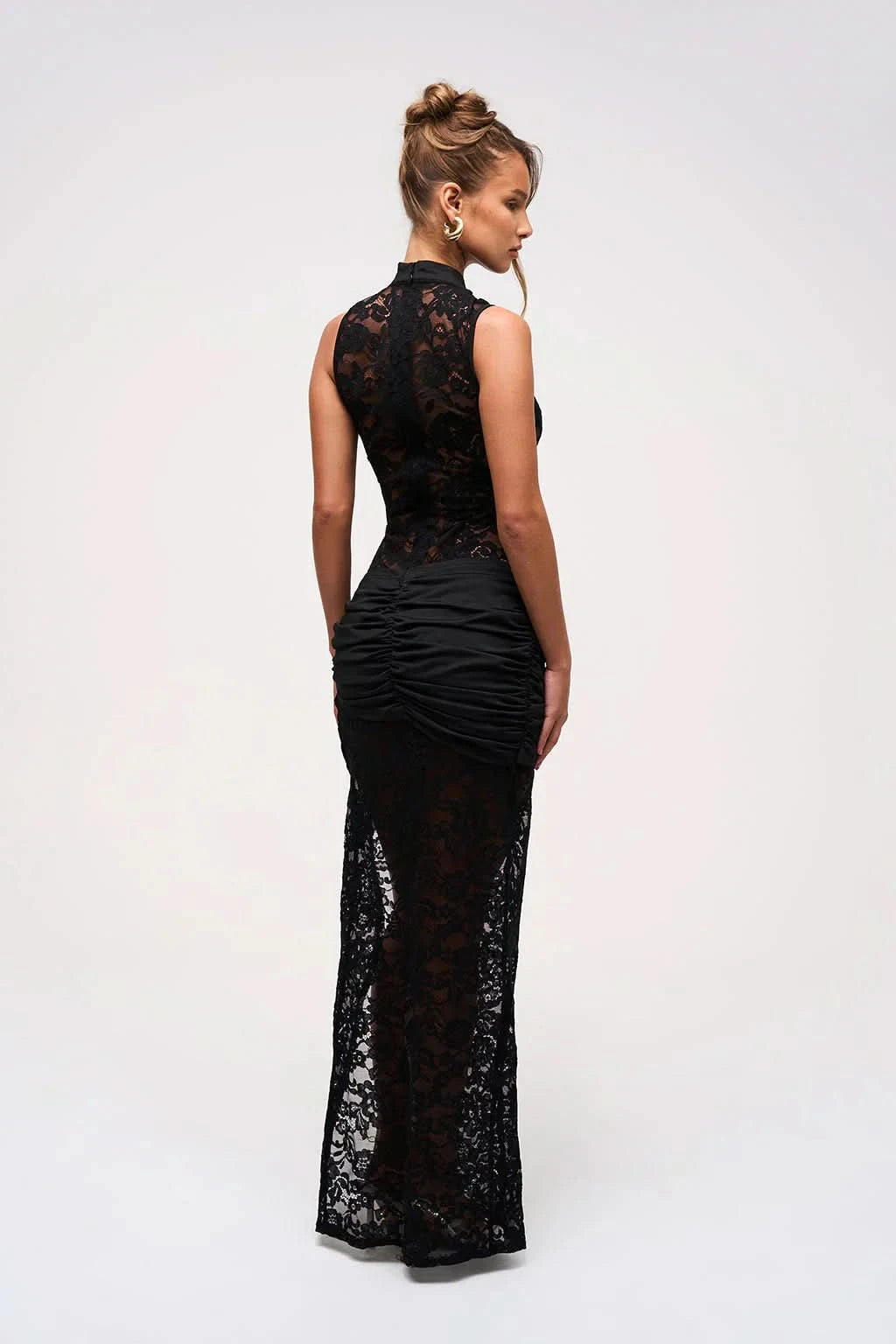 Back view of black lace maxi dress showing sheer lace panel and mock neck