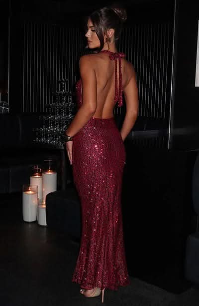 Back detail of burgundy sequin maxi dress showing open backless halter design