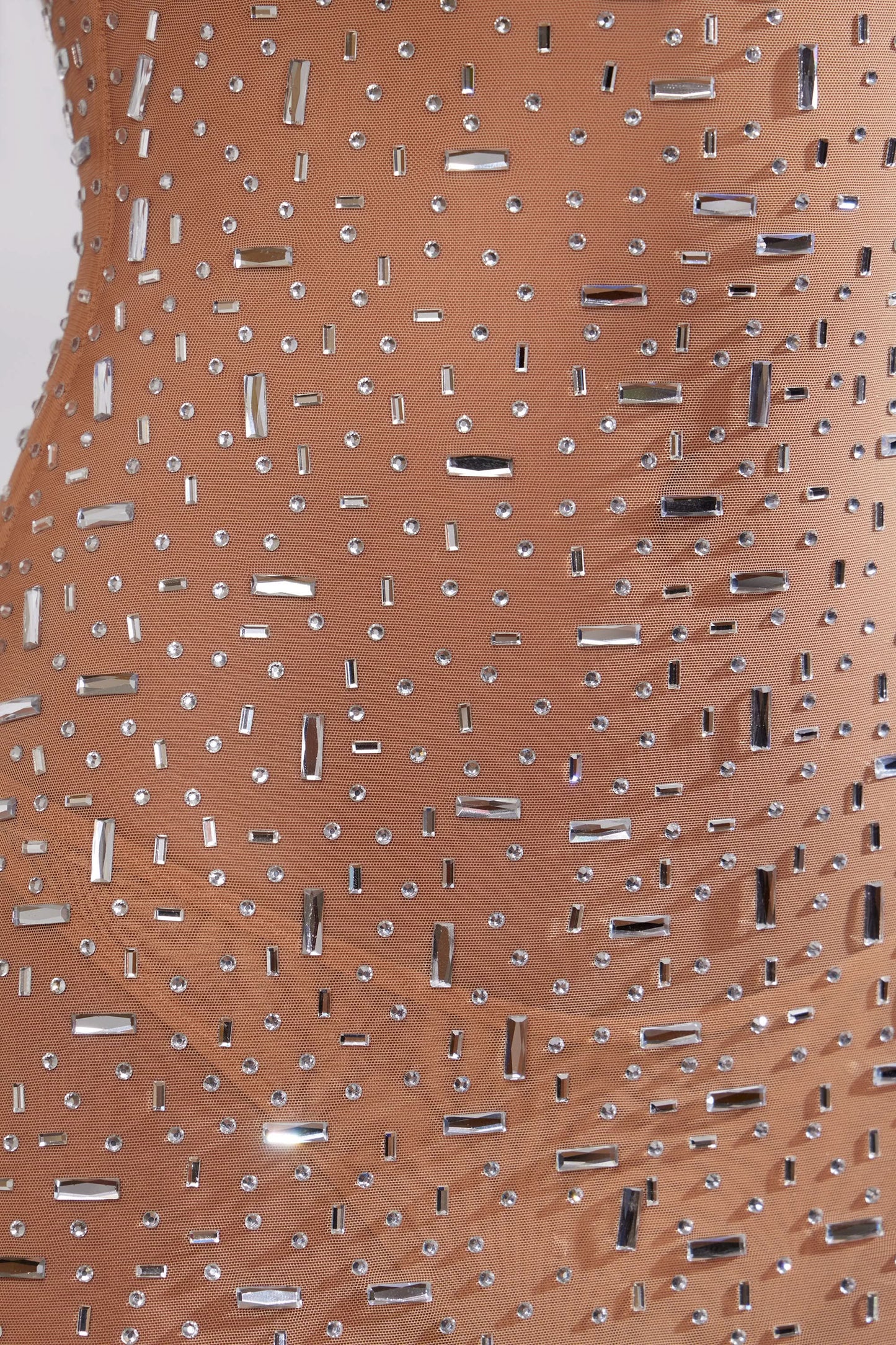 Close-up of champagne sequin fabric with rectangular and round sequins
