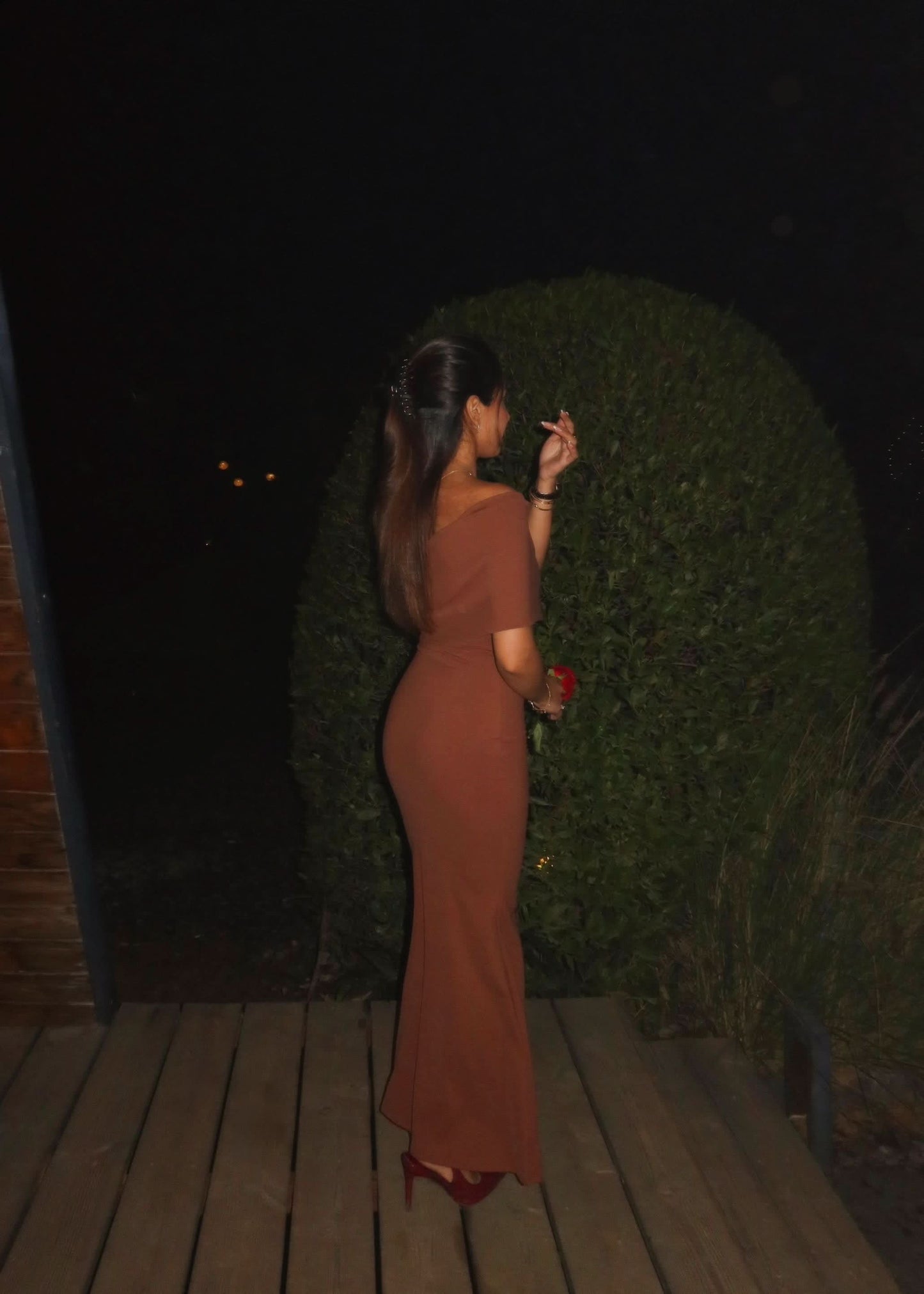 Back view of caramel maxi dress showing one-shoulder cut and fitted back