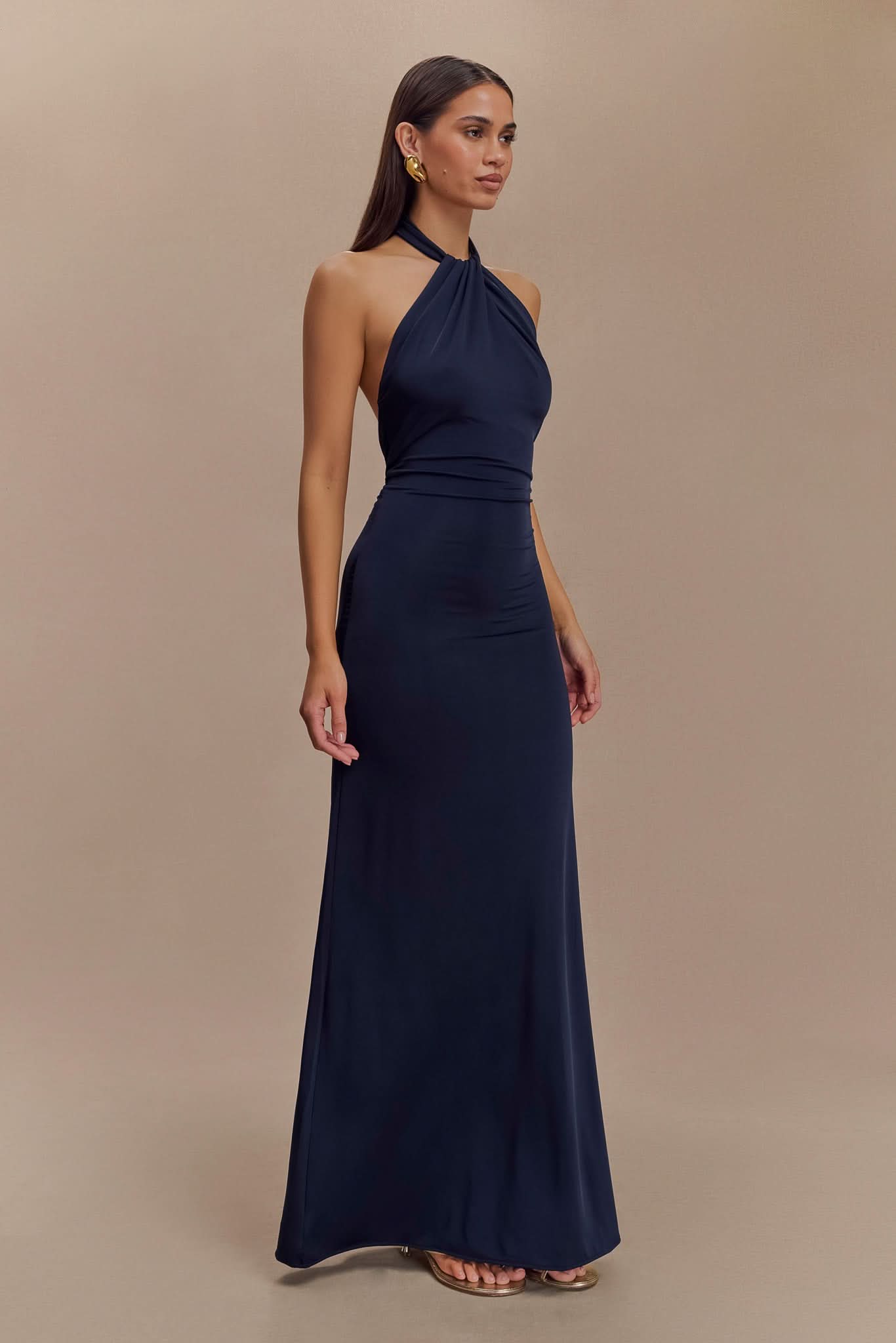 Navy halter maxi dress side view showing ruched waist and long skirt