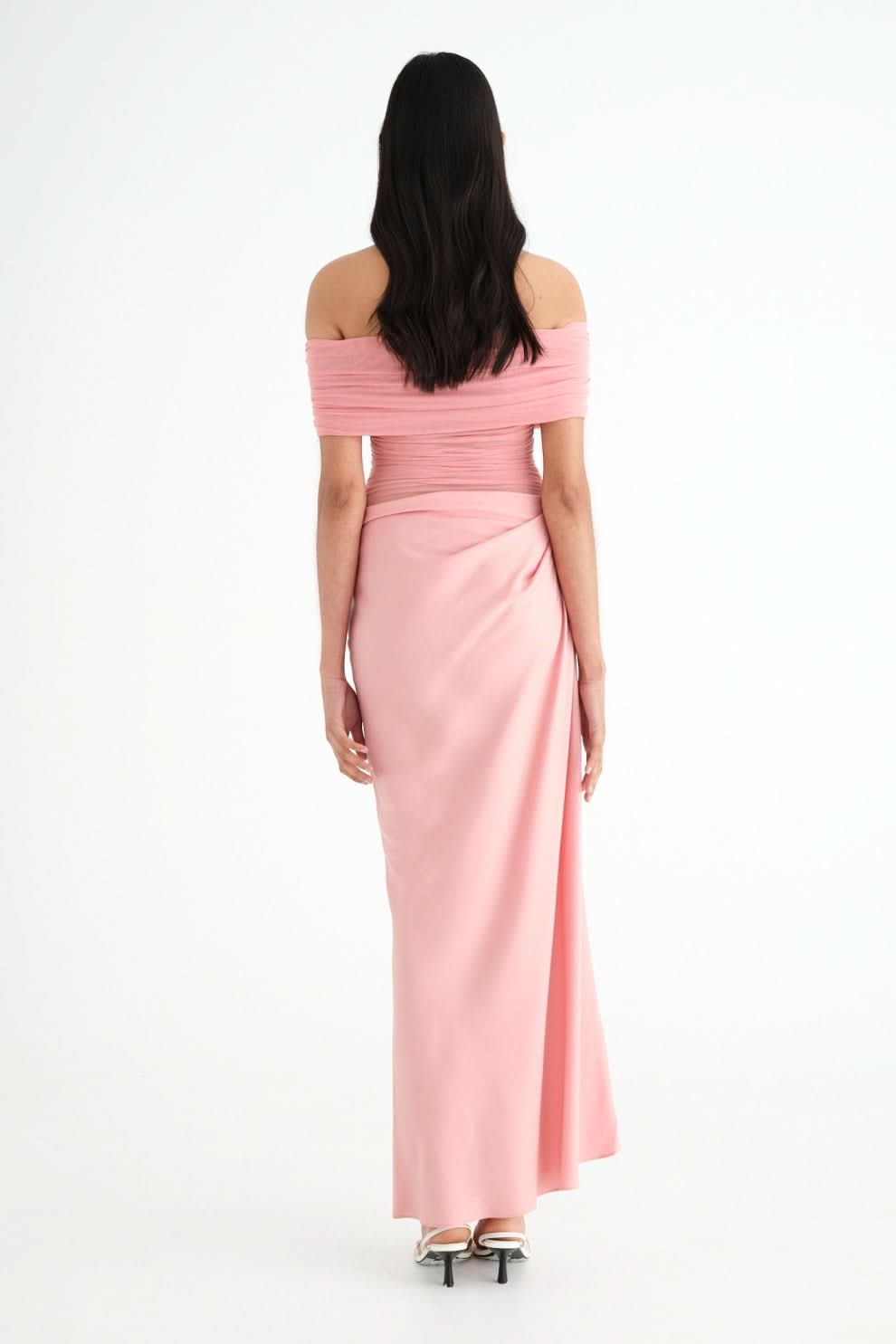 Back view of pink maxi dress with off-shoulder design and draped skirt