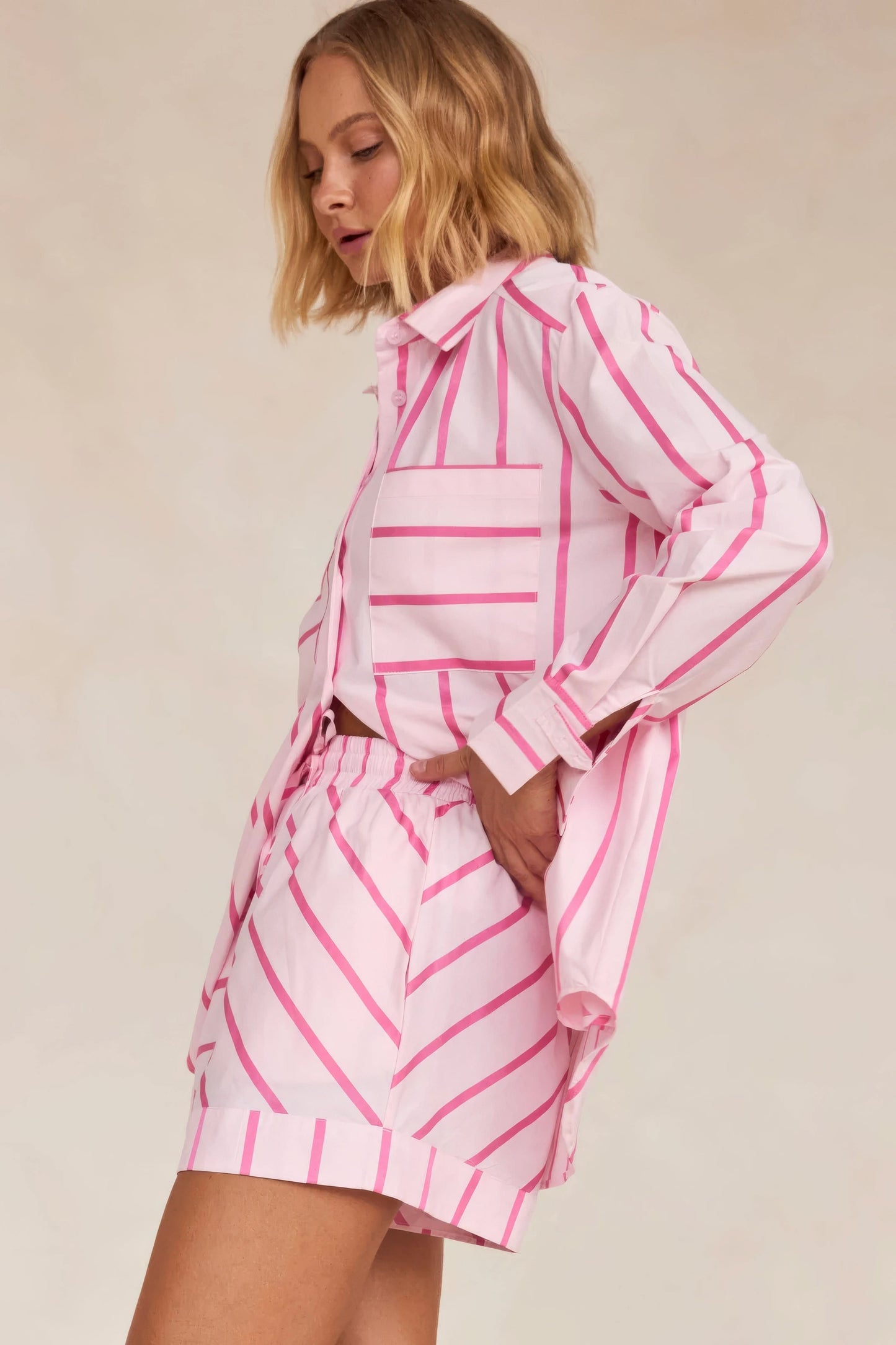 Back view of pink striped knit shirt with matching pleated skirt