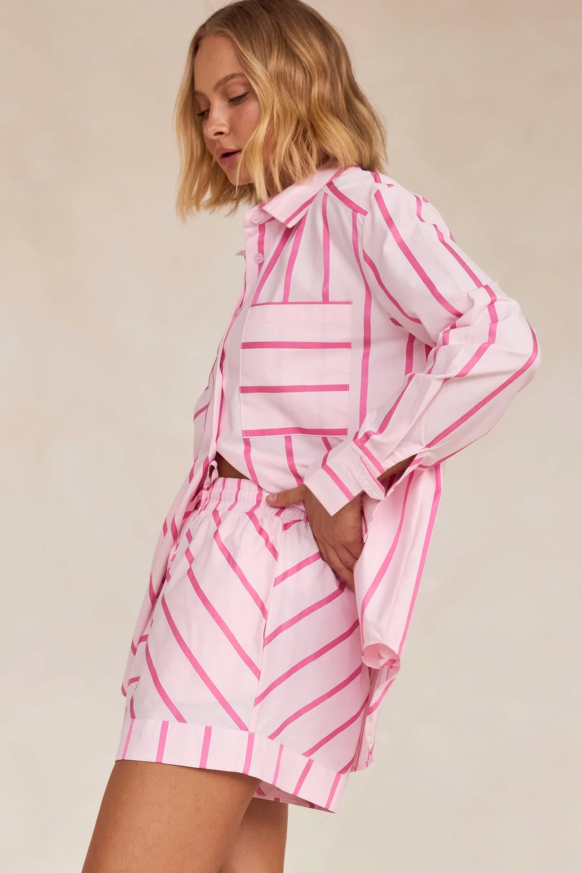 Back view of pink striped knit shirt with matching pleated skirt