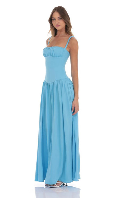 Side view of light blue satin maxi dress with flowing skirt