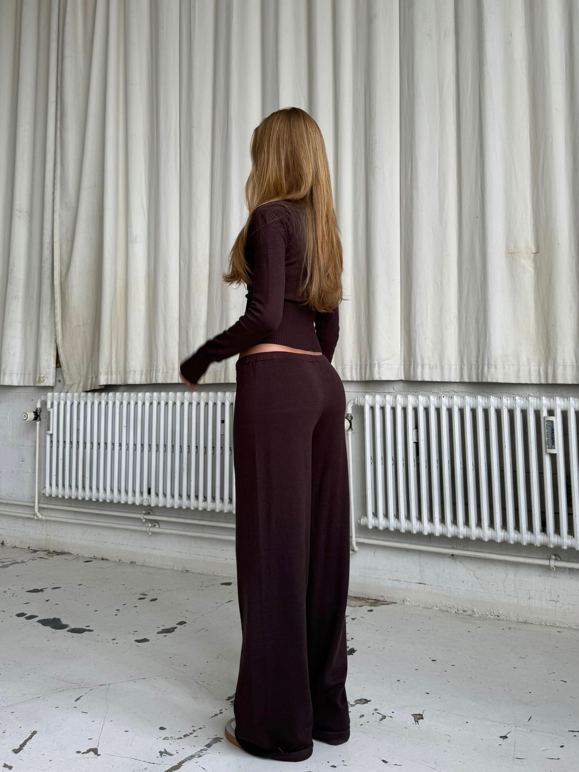 Dark brown knit two-piece with cropped cardigan and high-waist pants back view