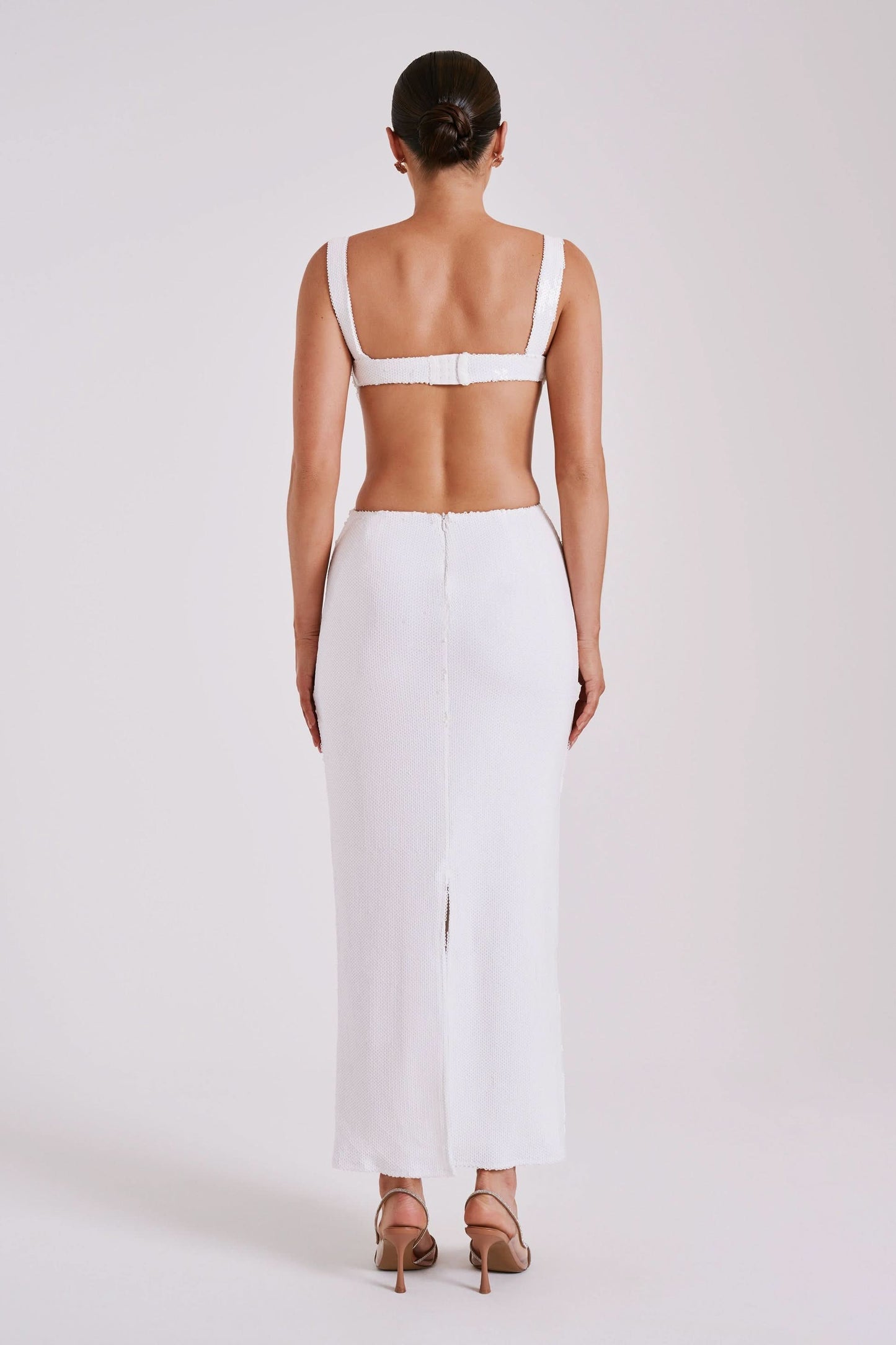 Back view of white ribbed maxi dress with open back detail