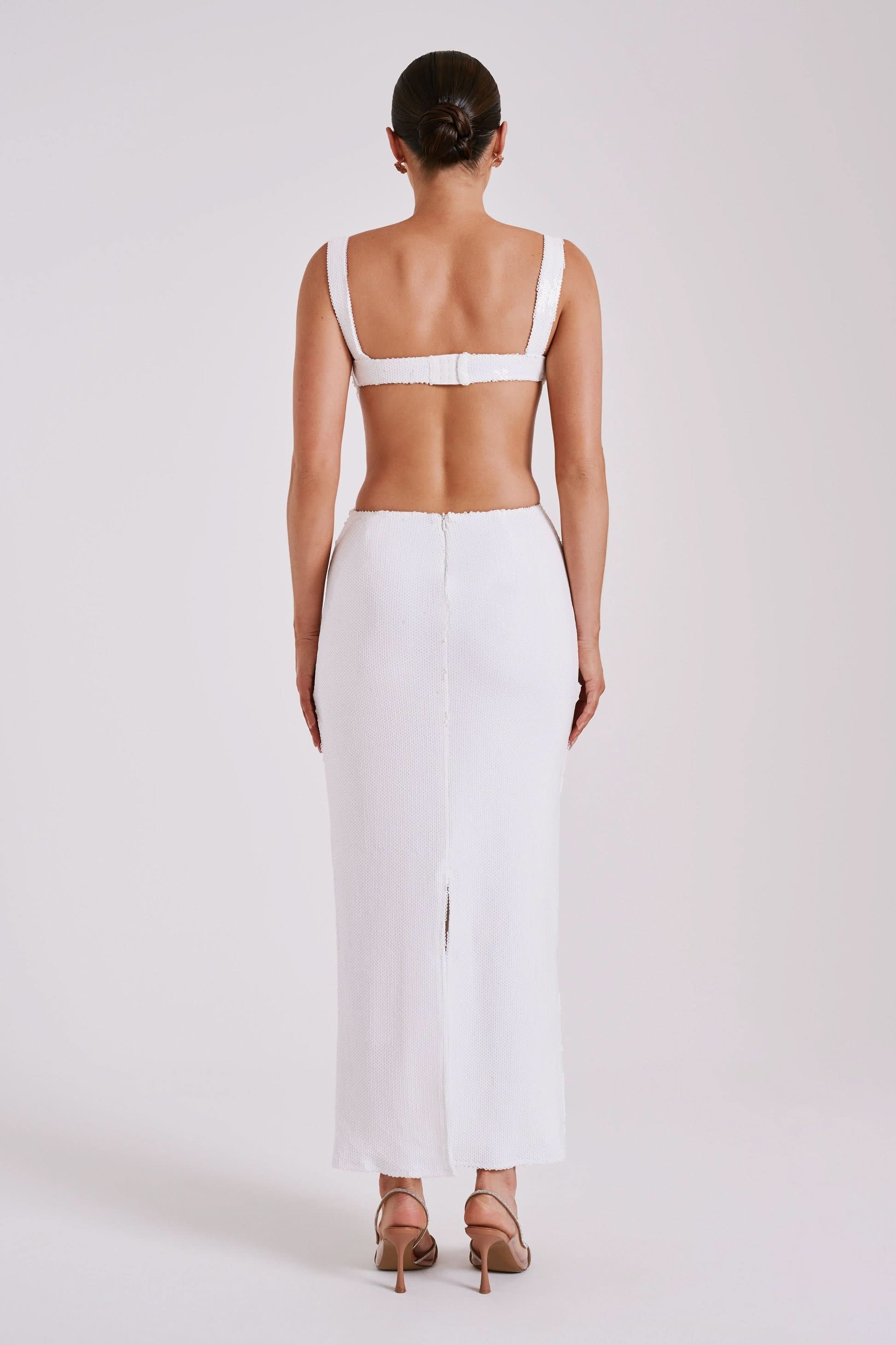 Back view of white ribbed maxi dress with open back detail