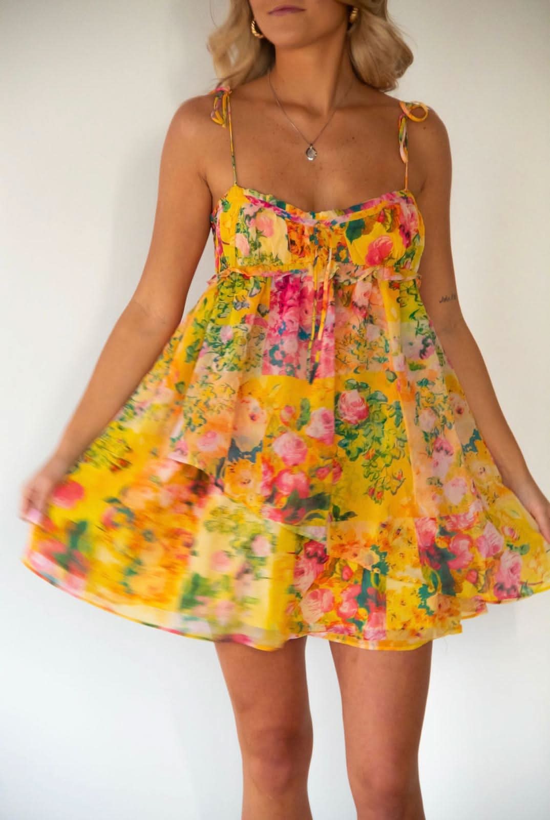 Front-facing floral mini dress with empire waist and colorful rose print