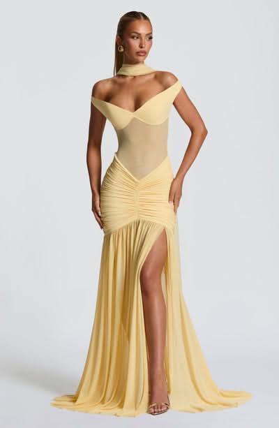 Pale yellow off-shoulder maxi dress with draped bodice and thigh slit
