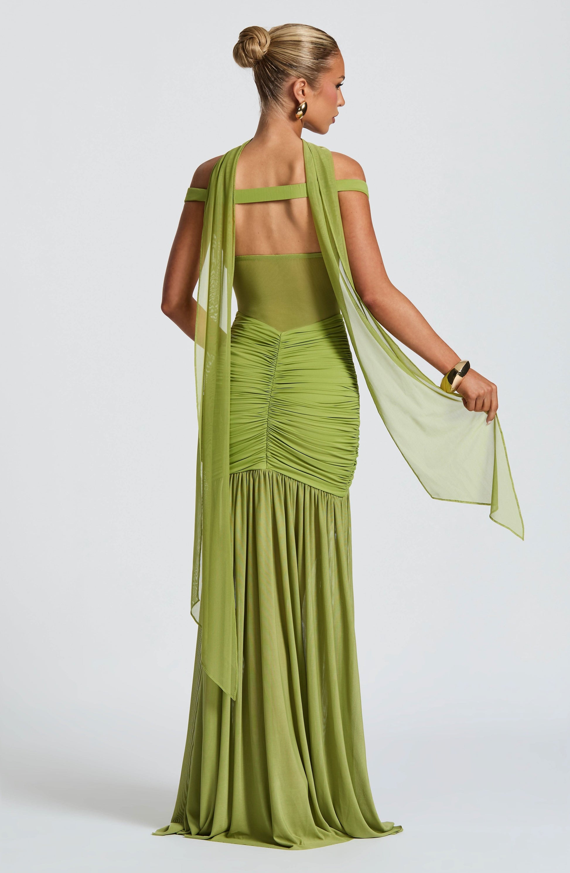 Back view of lime green maxi dress with open back and flowing train