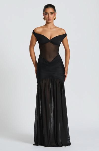 Black off-shoulder evening gown with sheer bodice and ruched skirt