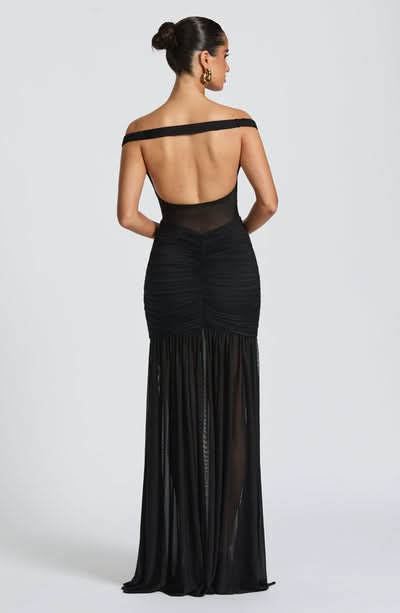 Back view of black formal maxi dress with open back design