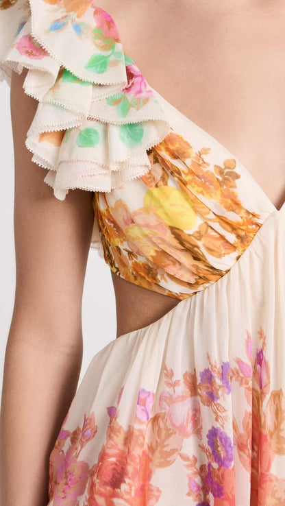 Close-up detail of ruffled cap sleeve and watercolor floral print on chiffon fabric