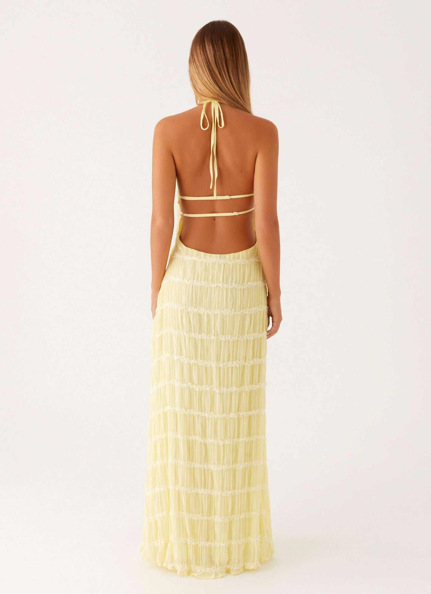 Pale yellow pleated halter maxi dress back view with tie straps