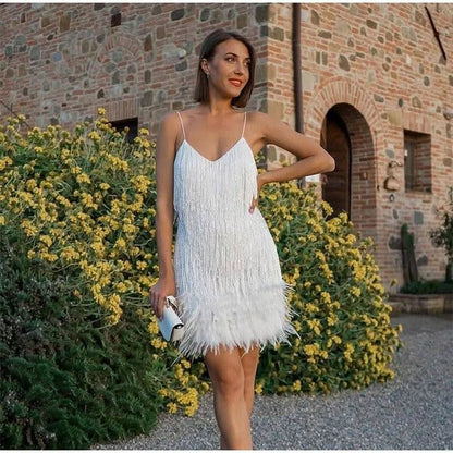 White feather mini dress with spaghetti straps and fringe hem