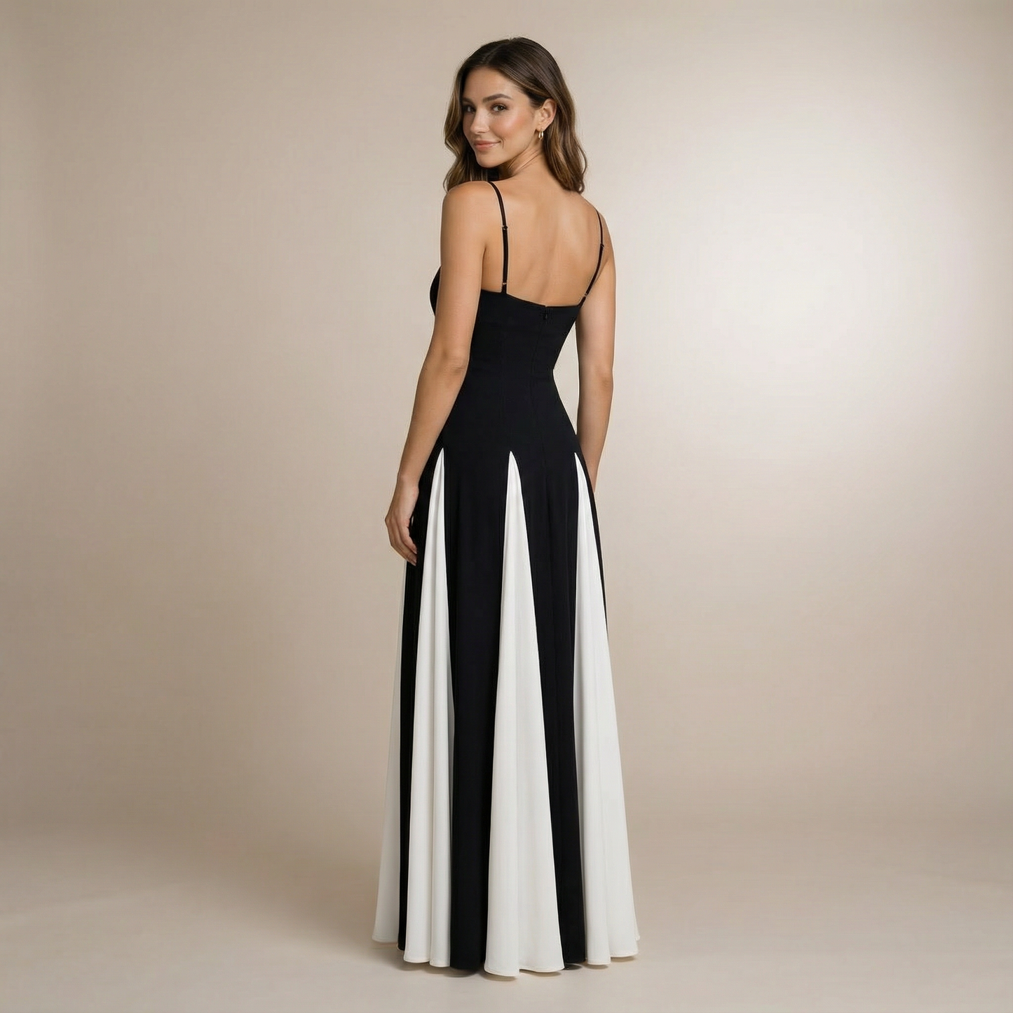Back view of black sweetheart maxi dress with open back and pleated white panel detail