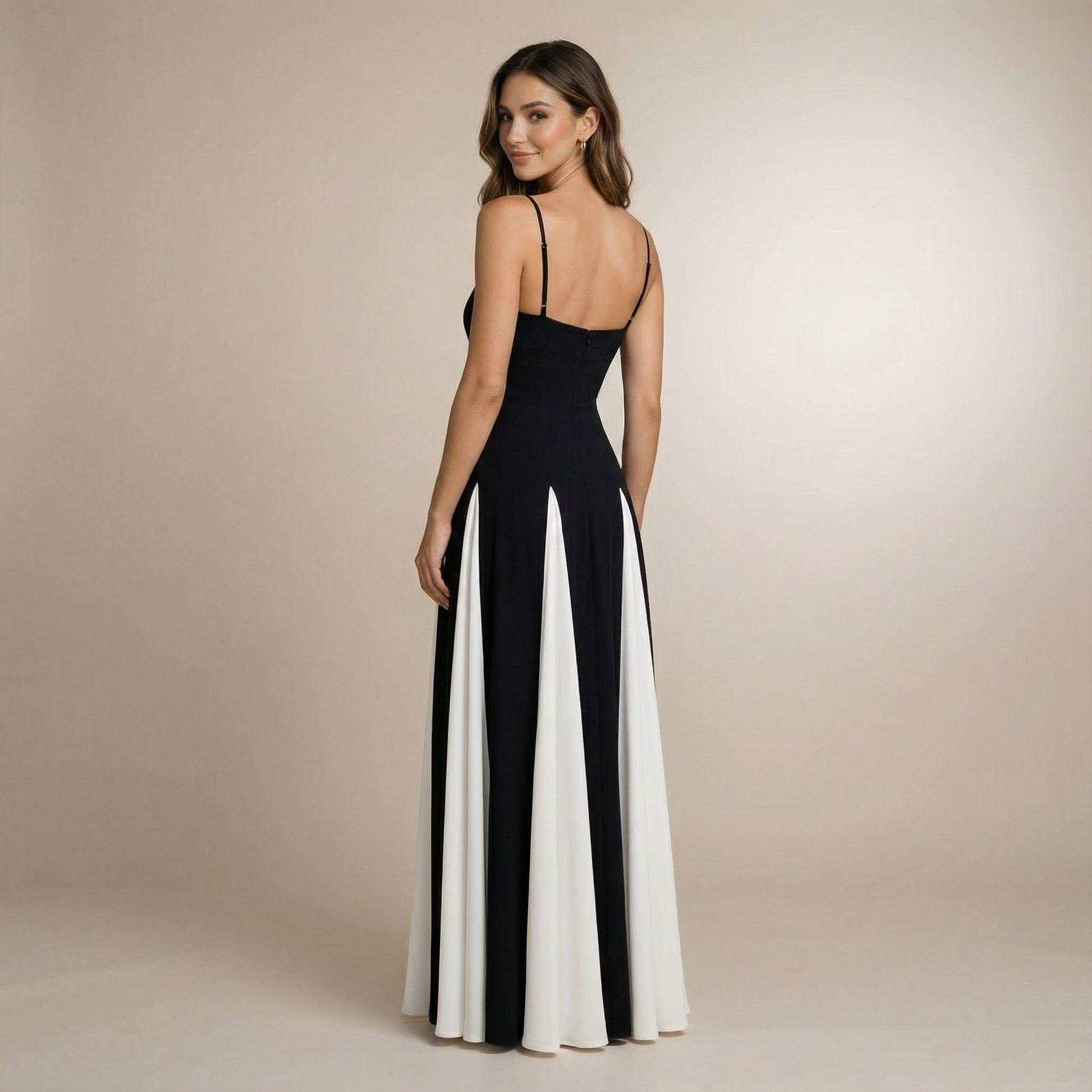 Back view of black sweetheart maxi dress with open back and pleated white panel detail