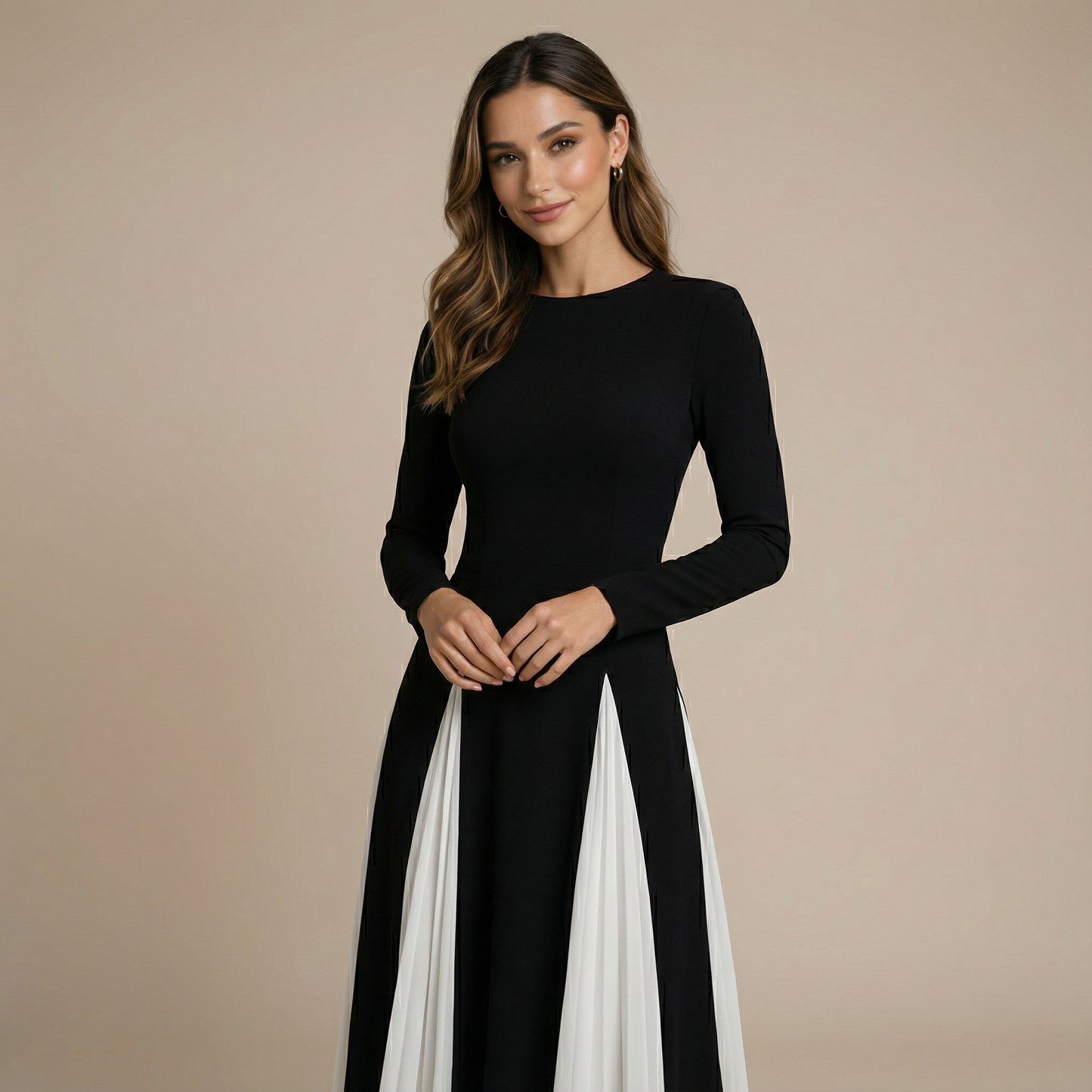 Close-up of long-sleeve colorblock maxi dress with fitted black bodice and draped white panels