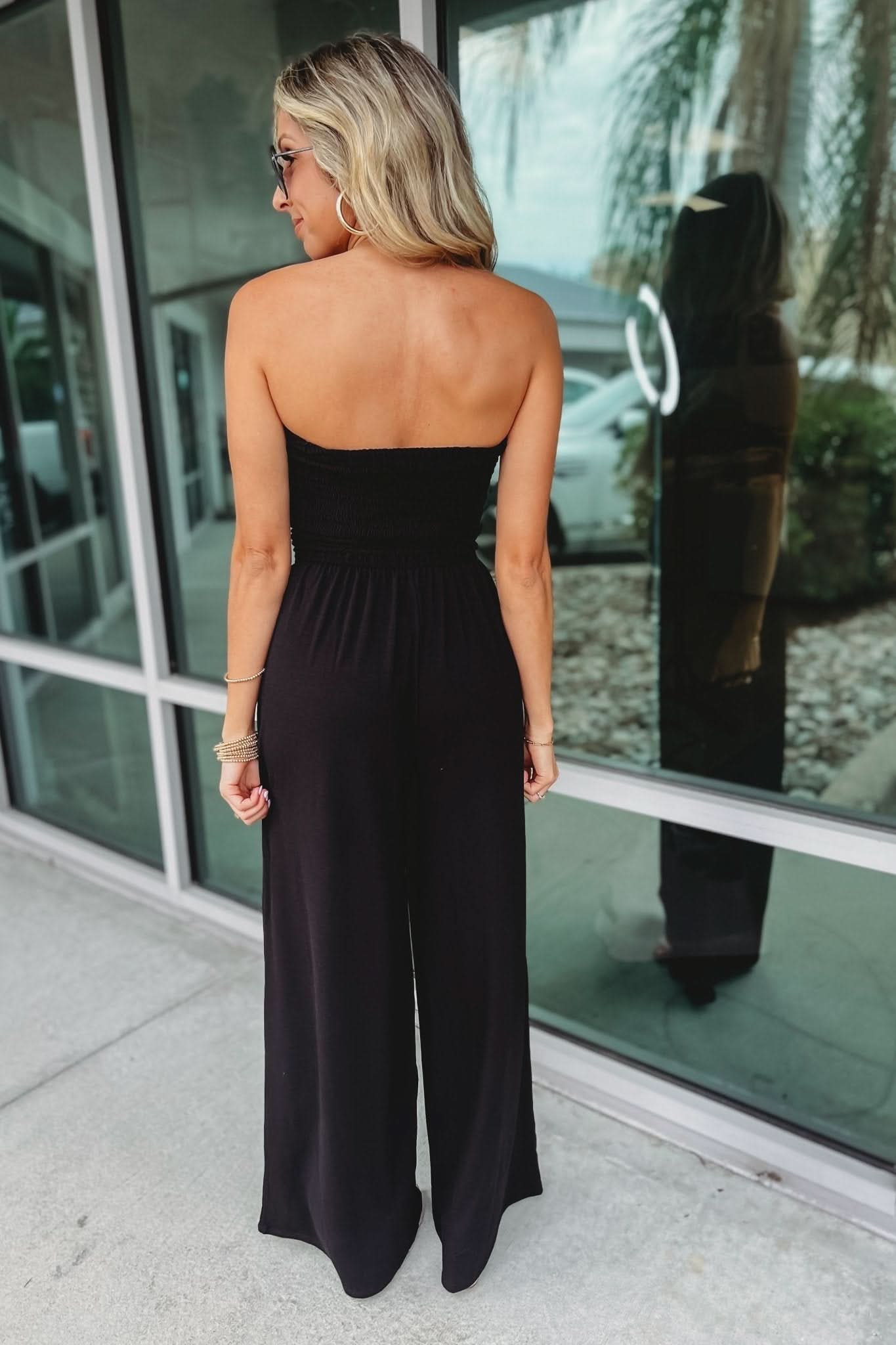 Back view of black strapless jumpsuit with open back design