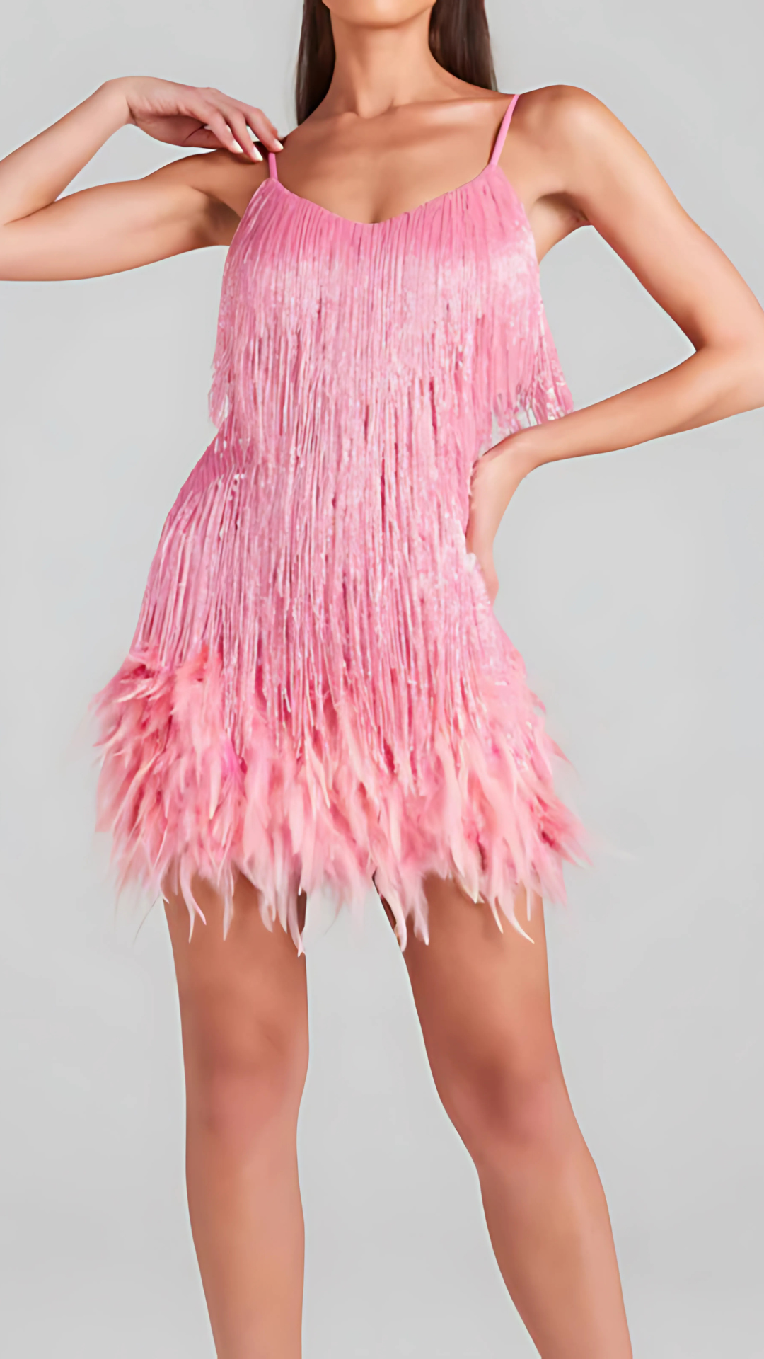 Pink fringed mini dress with spaghetti straps and layered fringe details