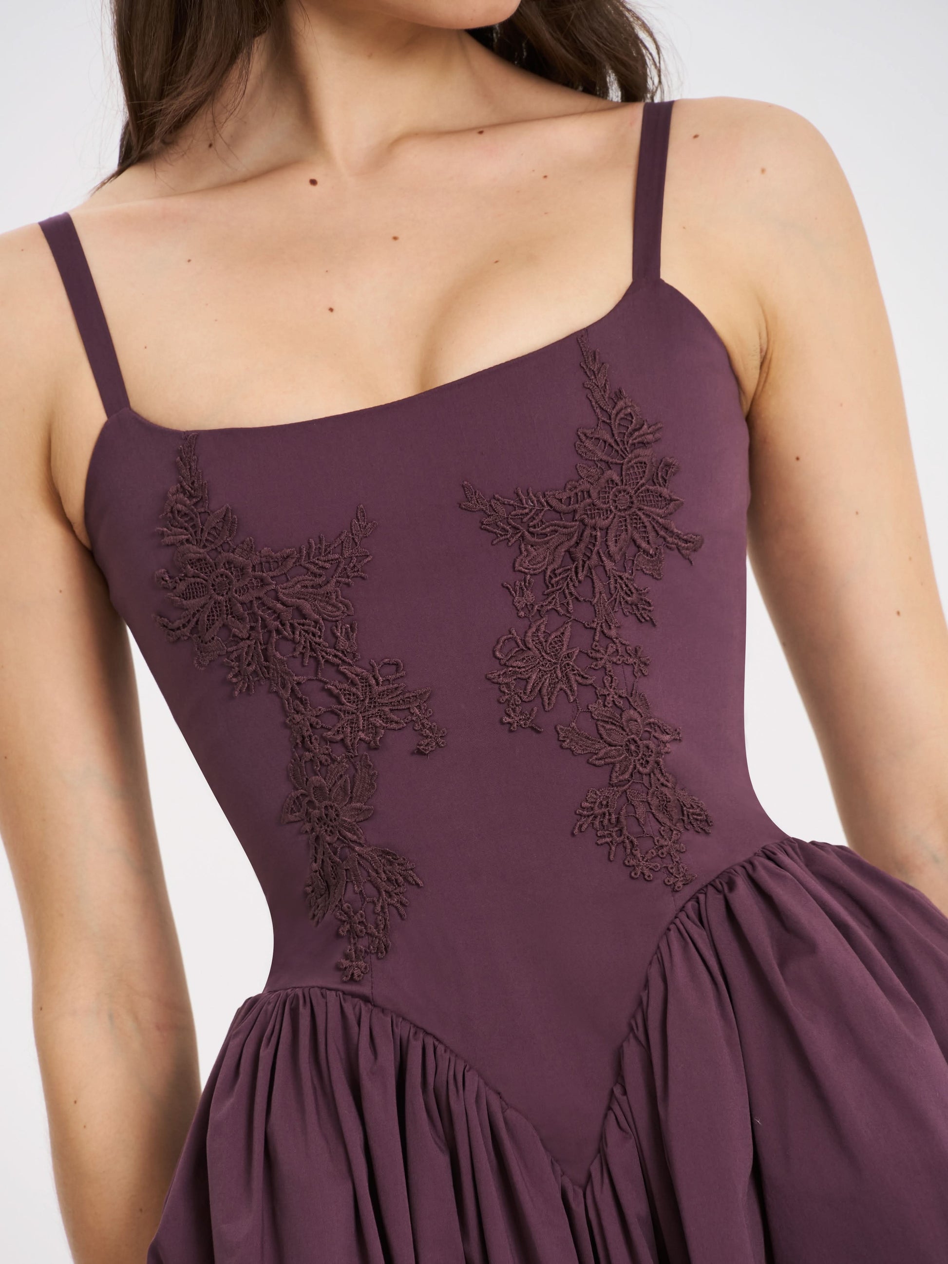 Lace embroidery bodice detail on deep purple spaghetti strap midi dress