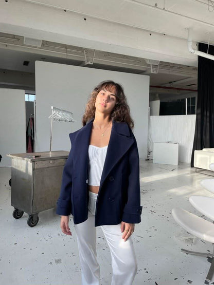 Navy blazer coat styled with white ribbed top and white pants
