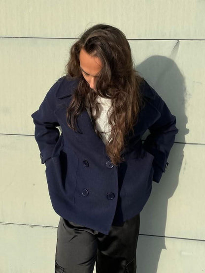 Navy double-breasted blazer with notch lapels and button front closure