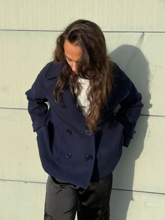 Navy double-breasted blazer with notch lapels and button front closure