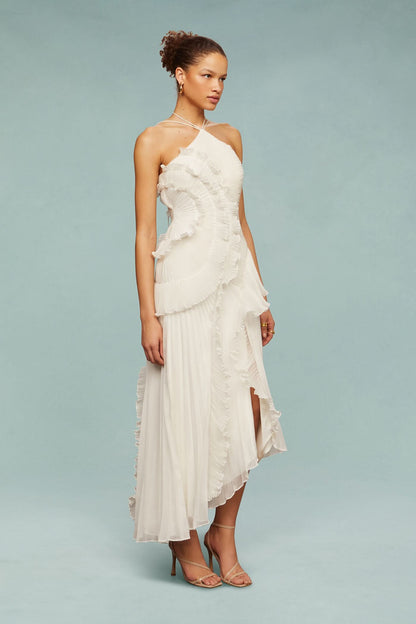 Side profile of cream halter dress with layered ruffle design