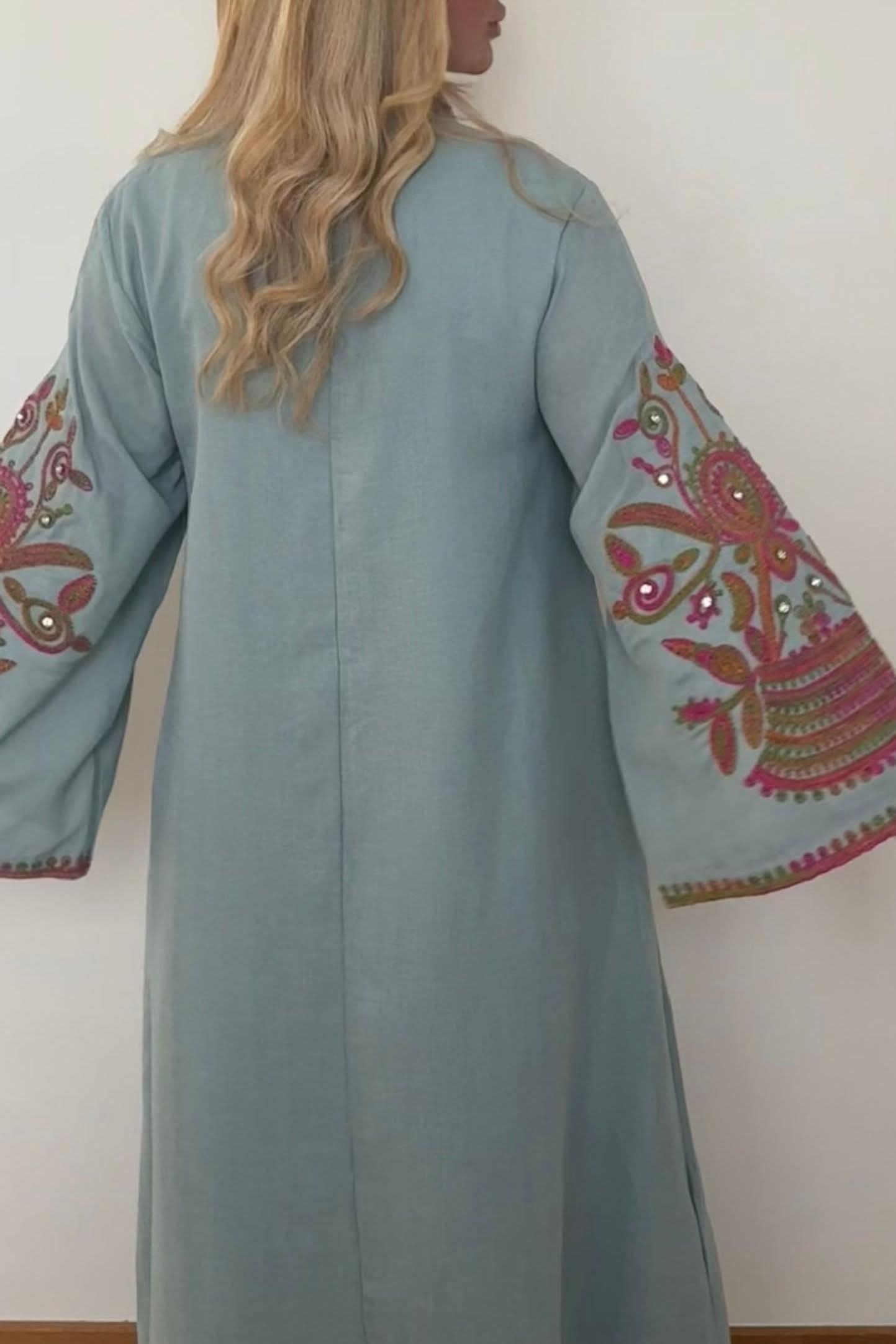 Back view of sage green kaftan with floral embroidered sleeves