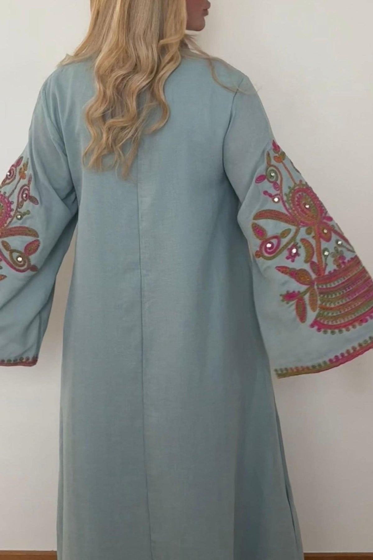 Back view of sage green kaftan with floral embroidered sleeves