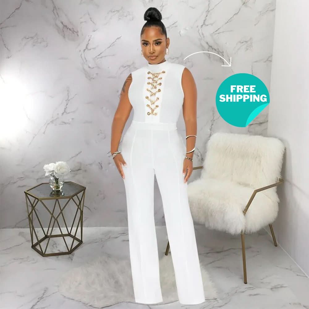 White sleeveless jumpsuit with gold chain lace-up front detail and wide legs