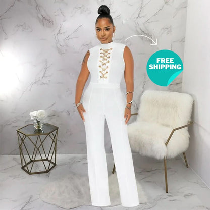 White sleeveless jumpsuit with gold chain lace-up front detail and wide legs
