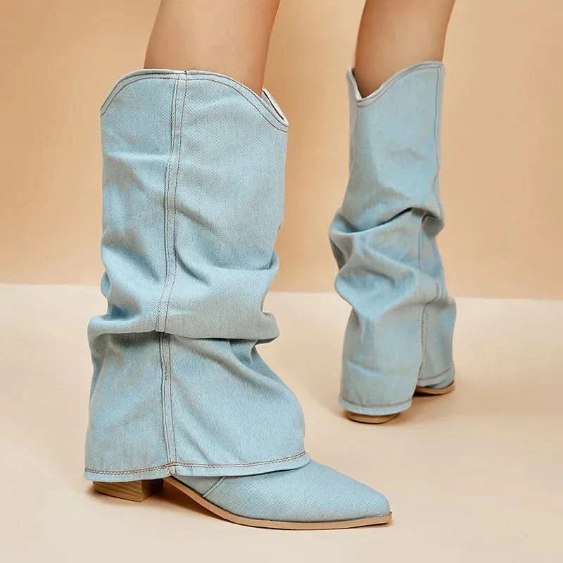 Overhead view of light blue denim mid-calf boots with slouchy fit and pointed toe