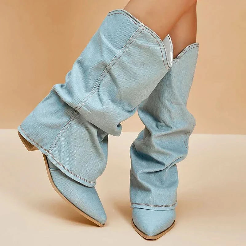 Three-quarter view of light blue denim slouchy pull-on boots with pointed toe for women