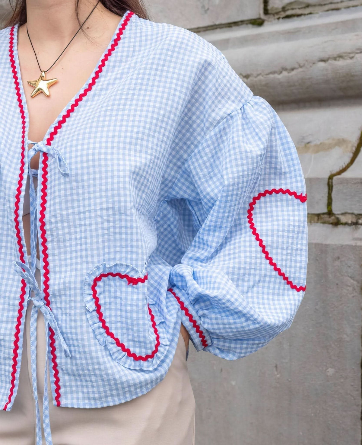 Light blue gingham heart top with red scalloped edges and tie front detail