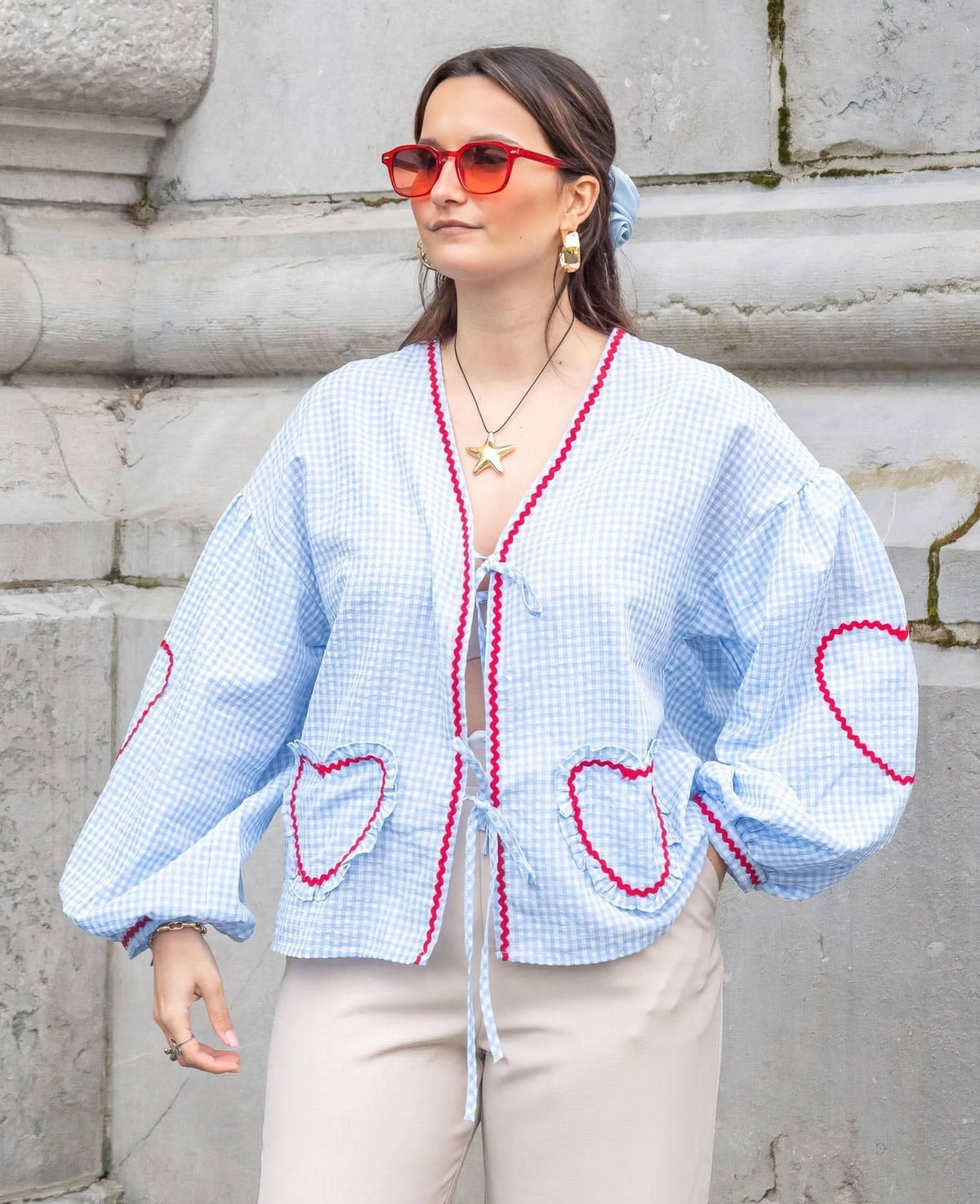 Light blue gingham heart top with red scalloped trim and tie closure detail