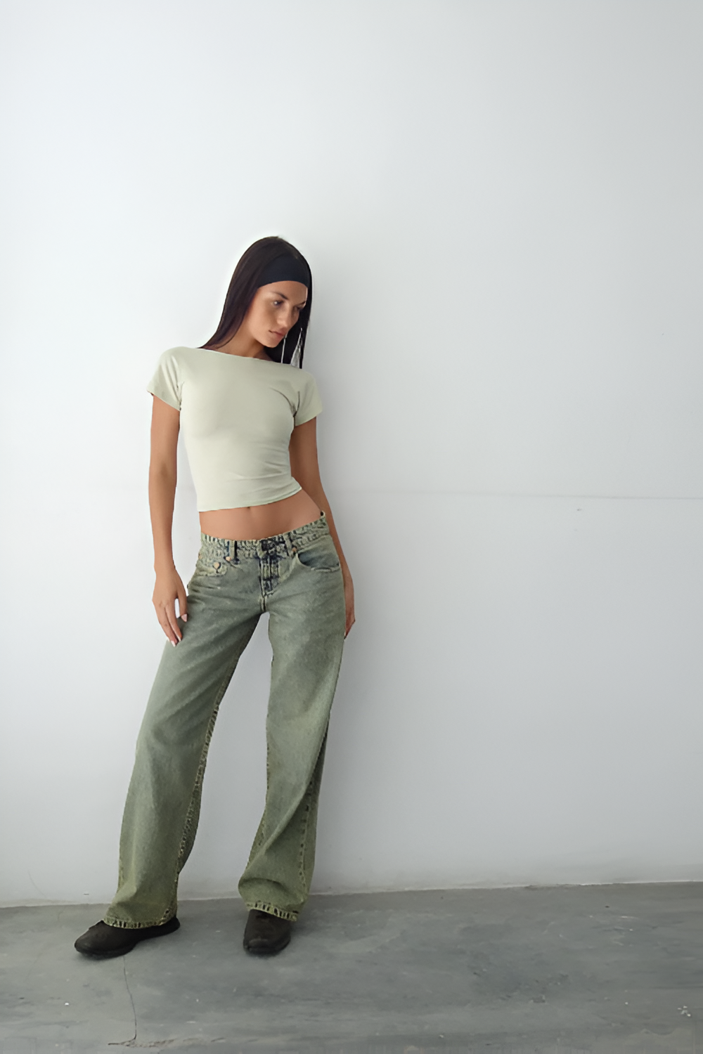 Sage green low-rise jeans with wide-leg cut and worn-in finish