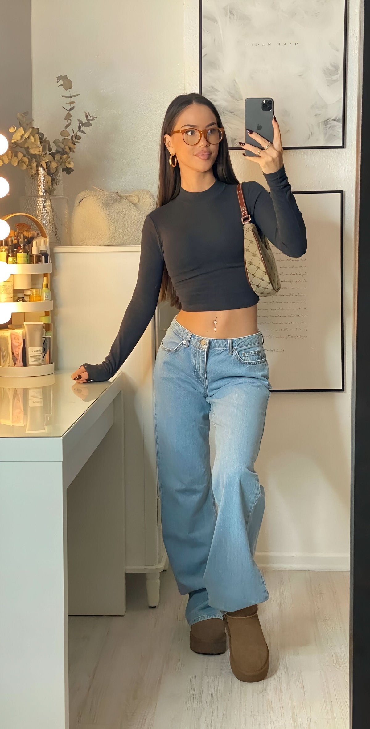 Light wash low-rise jeans paired with black long-sleeve crop top