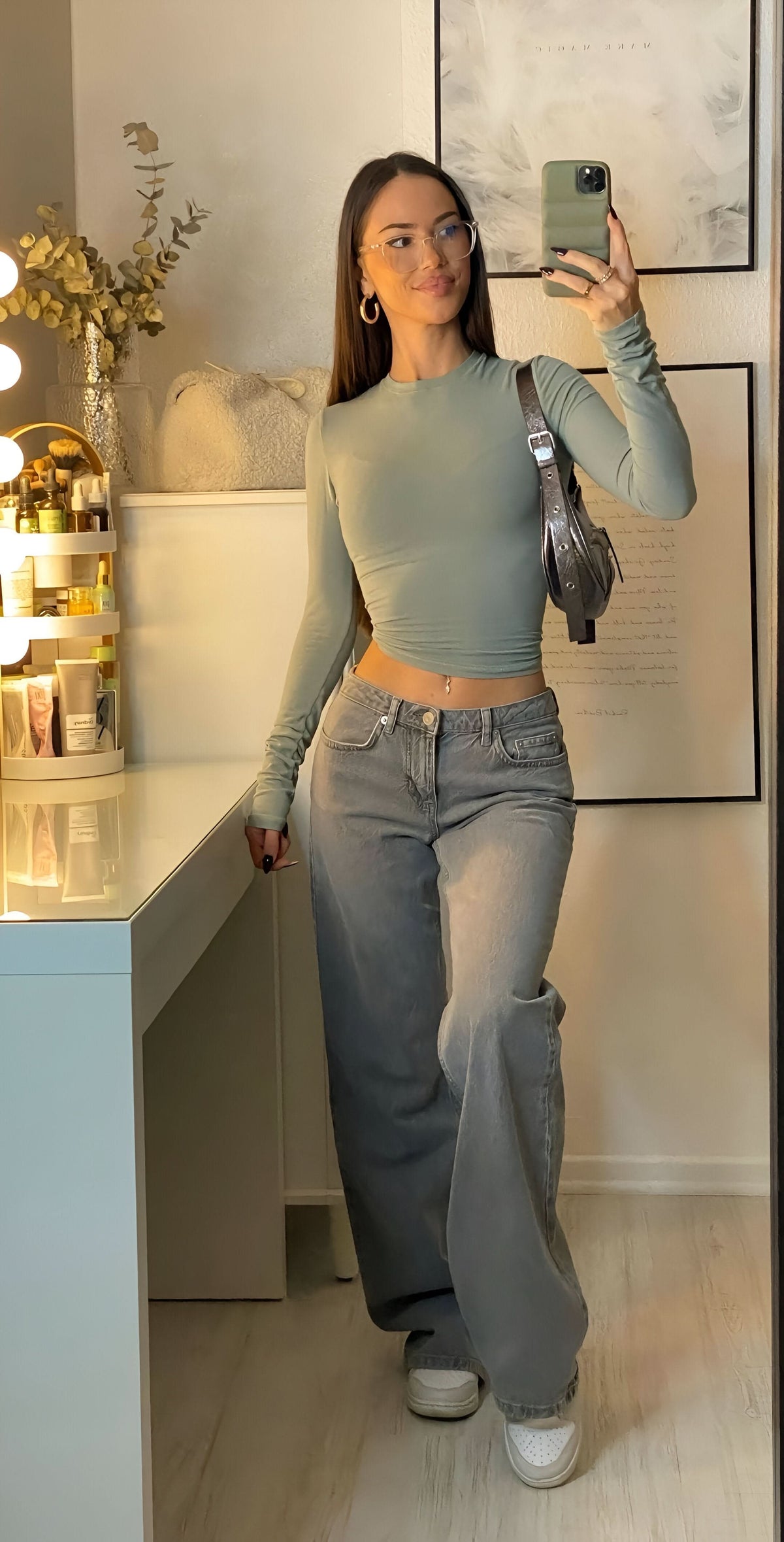 Faded gray low-rise jeans with sage green fitted long-sleeve crop