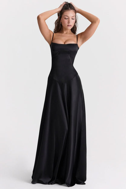 Black sleeveless maxi dress with thin straps and flowing silhouette