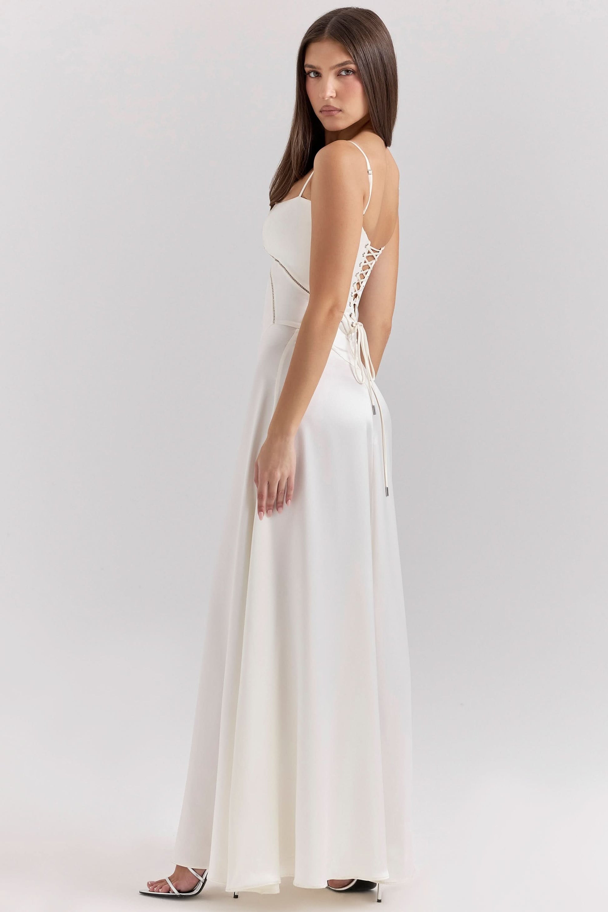 Side view of cream lace-up maxi dress with open back design