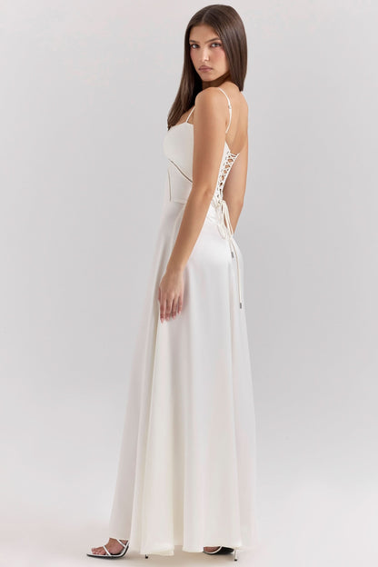 Side view of cream lace-up maxi dress with open back design