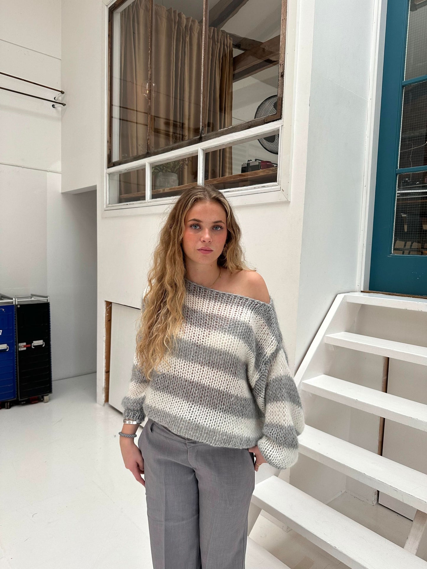 Gray and white striped knit sweater with off-shoulder neckline
