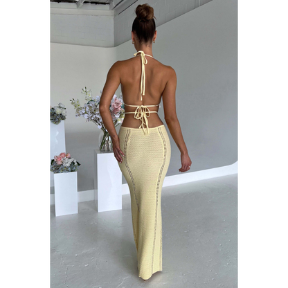 Cream textured maxi dress back view with halter straps and cutout details