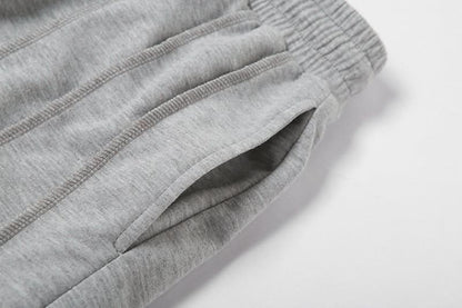 Close-up of gray sweatpants side pocket detail