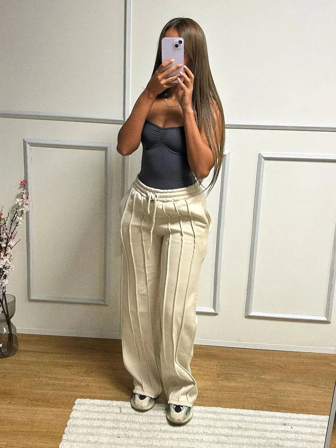 Cream high waist sweatpants with vertical pleats and drawstring waist